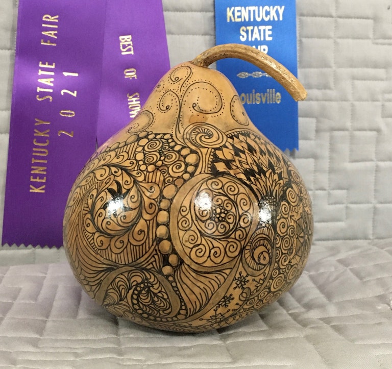 blue ribbon winning gourd art with intricate design